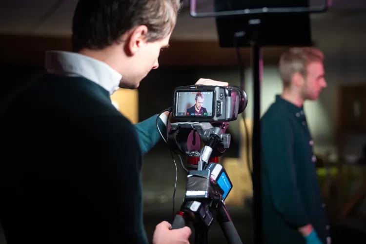 Man with camera filming Luke Tome from History Hit
