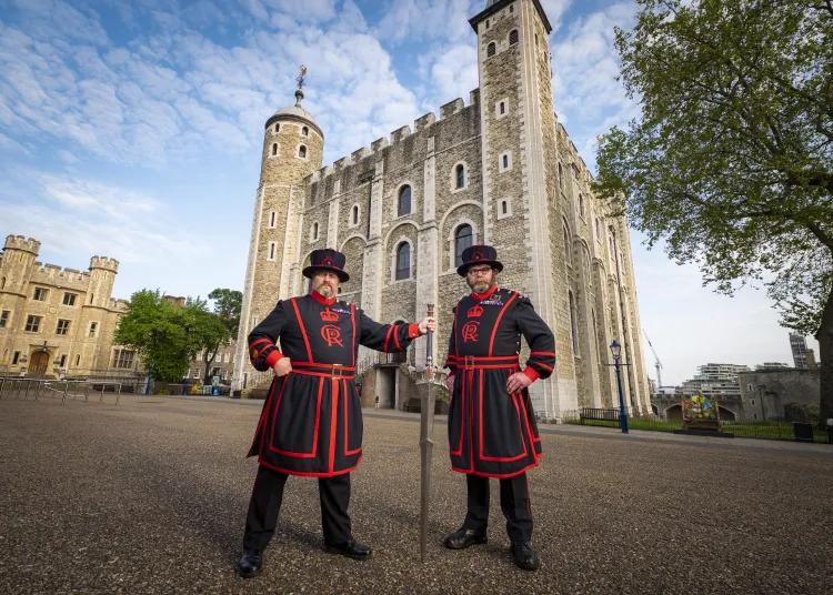 Two Yeoman Warder with the FINAL FANTASY XVI Invictus Sword in front of the white tower at the Tower of London