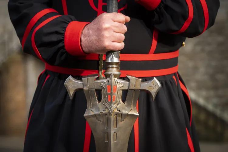 Yeoman Warder holding FINAL FANTASY XVI Invictus Sword hilt