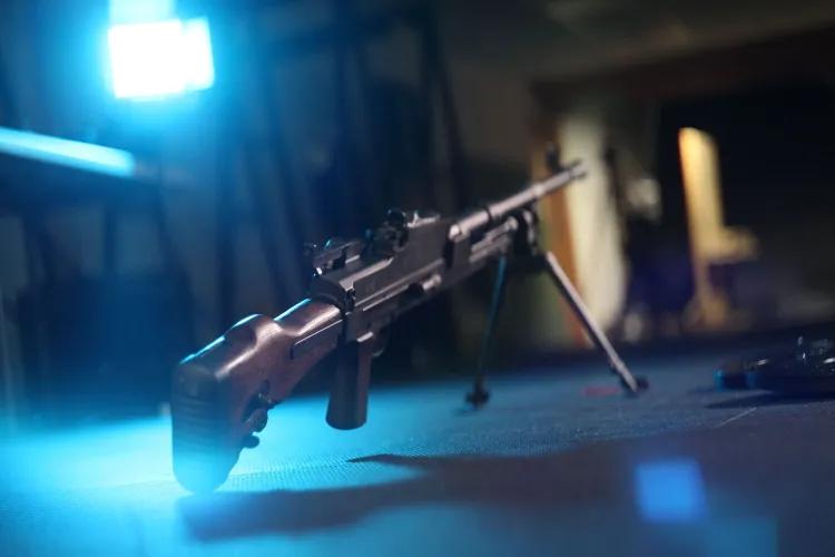 BREN machine gun with bright blue light behind.