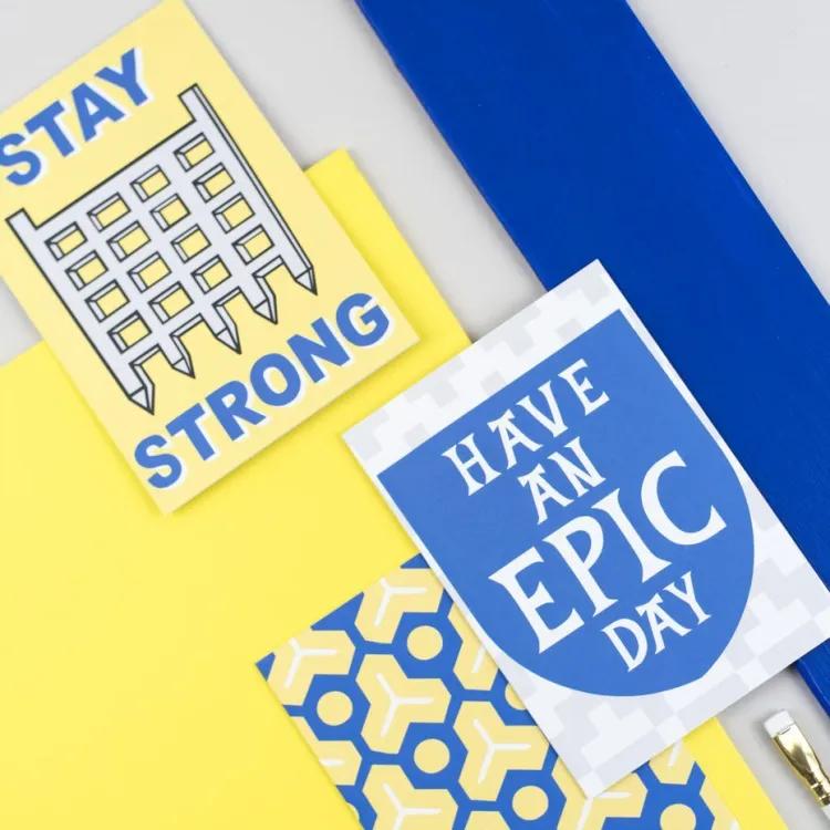 greetings cards with paintbrush on a yellow and blue background