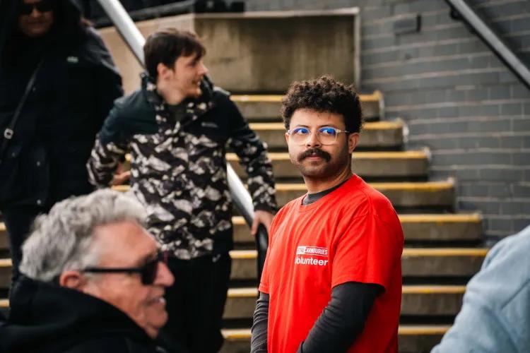 A member of staff in a red t-shirt supervises an event in the Tiltyard