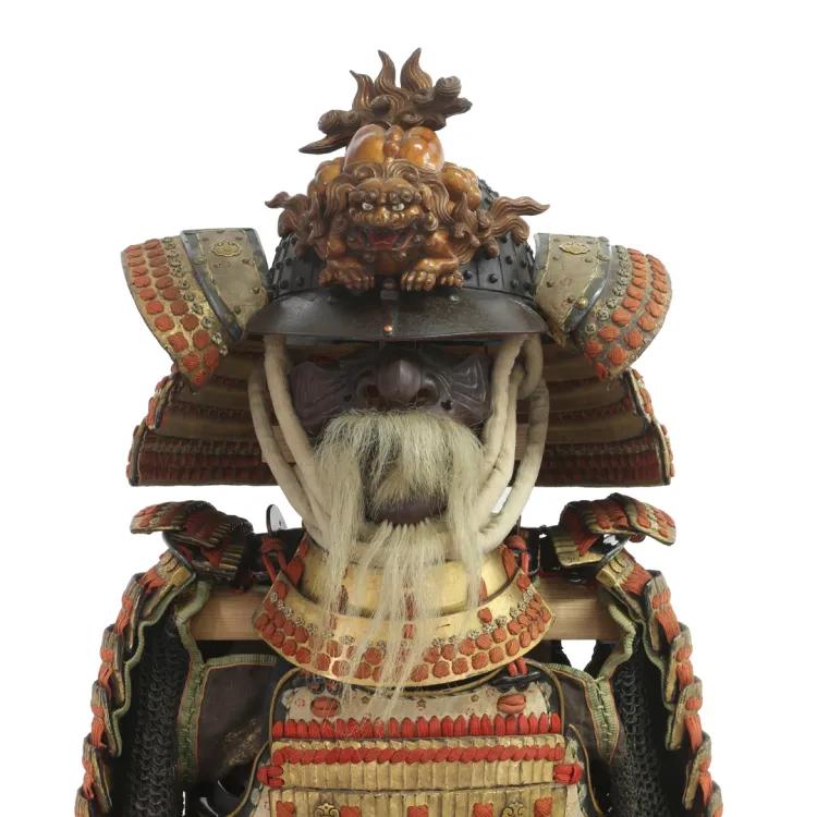 A suit of lacquered armour in feudal Japanese style with ornamented helmet and fake beard