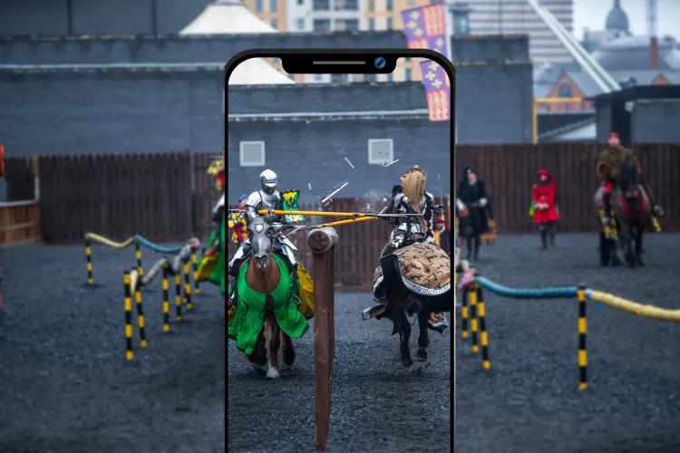 A mobile phone graphic displaying a sharp image of jousting 