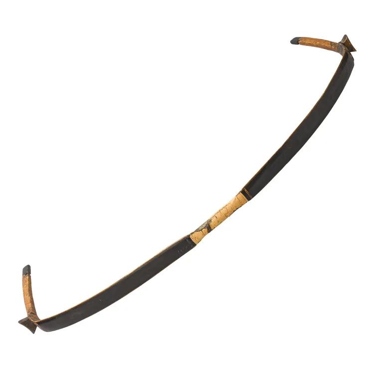 An unstrung composite bow in black wood with yellow tips