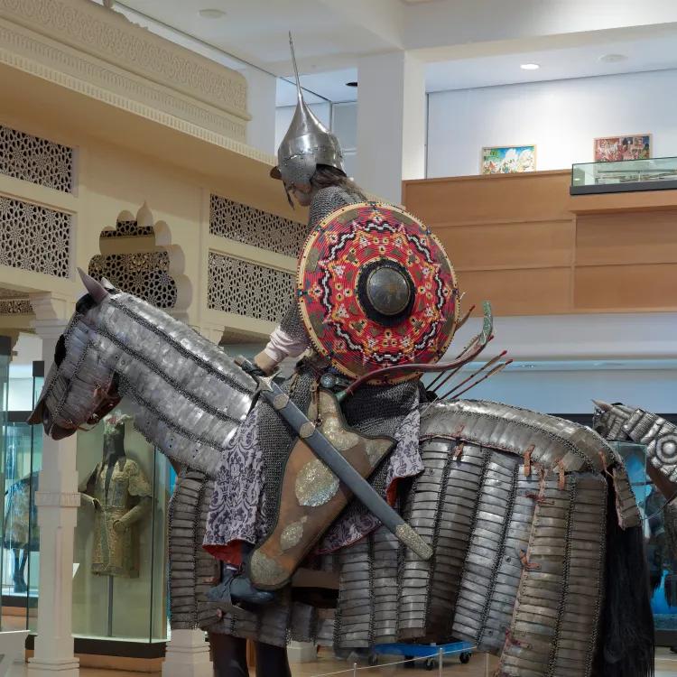 A mannequin in late 15th century Turkish armour on top of a horse mannequin clad in lamellar armour
