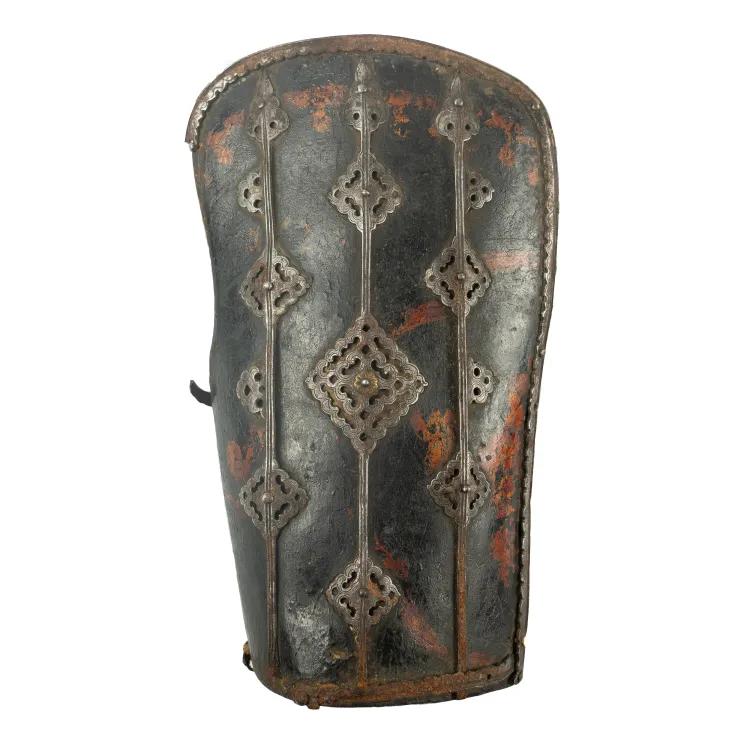 A leather bracer in black and red, banded with decorated metal ribs