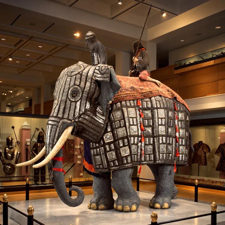 Model of an elephant wearing armour with two "riders"