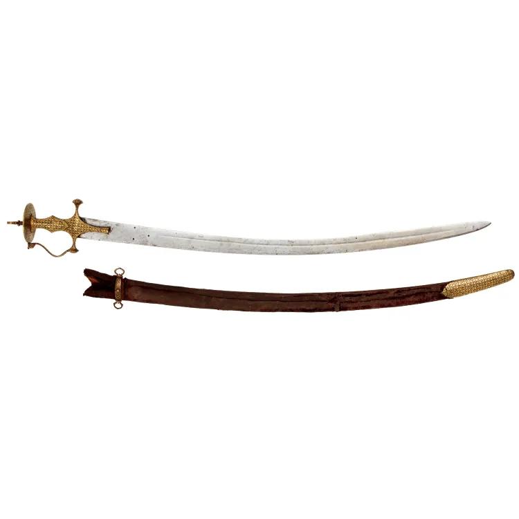 A curved sword with a decorative golden handle and wooden scabbard