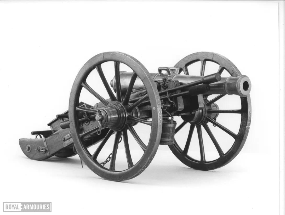 A large gun with big wheels 