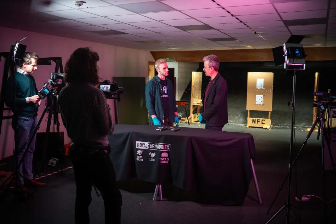 Jonathan Ferguson and Luke Tome being filmed at a firing range for History Hit program