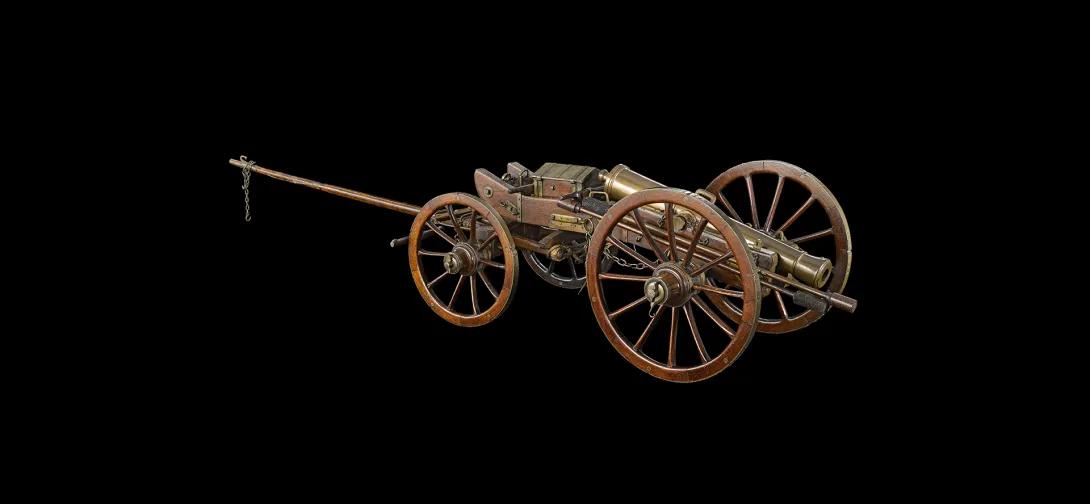 a bronze cannon/gun mounted on a limber with four wheels