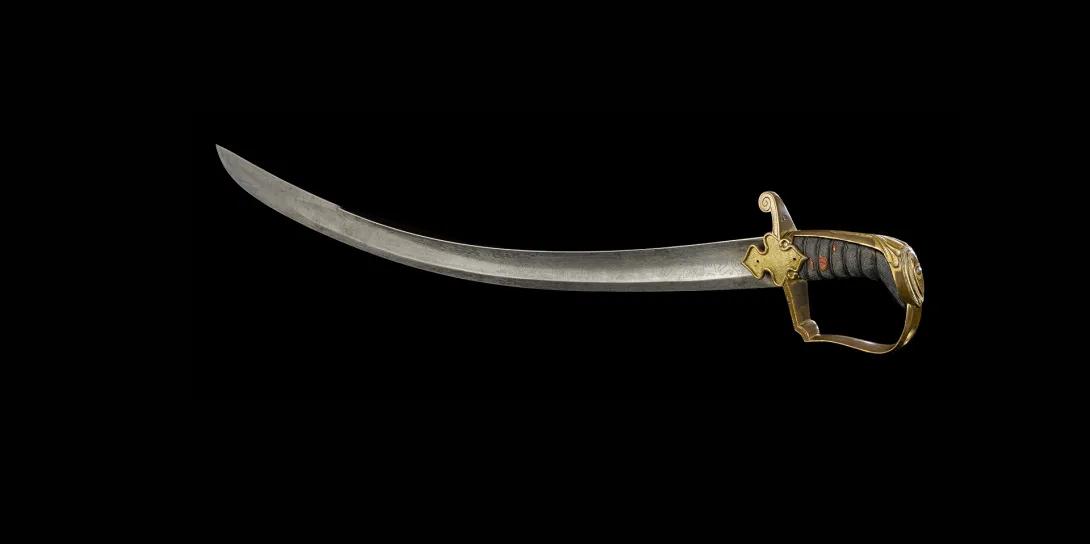 Sword with curved single edged blade, brass hilt and knuckle bow with textured grip